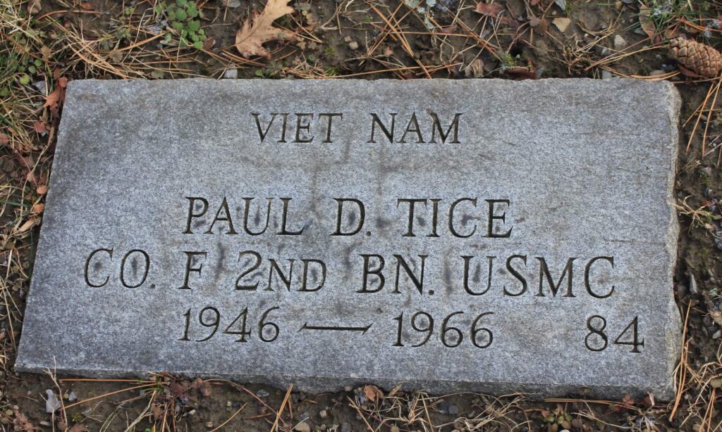 Small, flat grave engraved with "Viet Nam Paul D. Tice Co. F 2nd BN. USMC 1946-1966." It is also marked as grave number 84. 