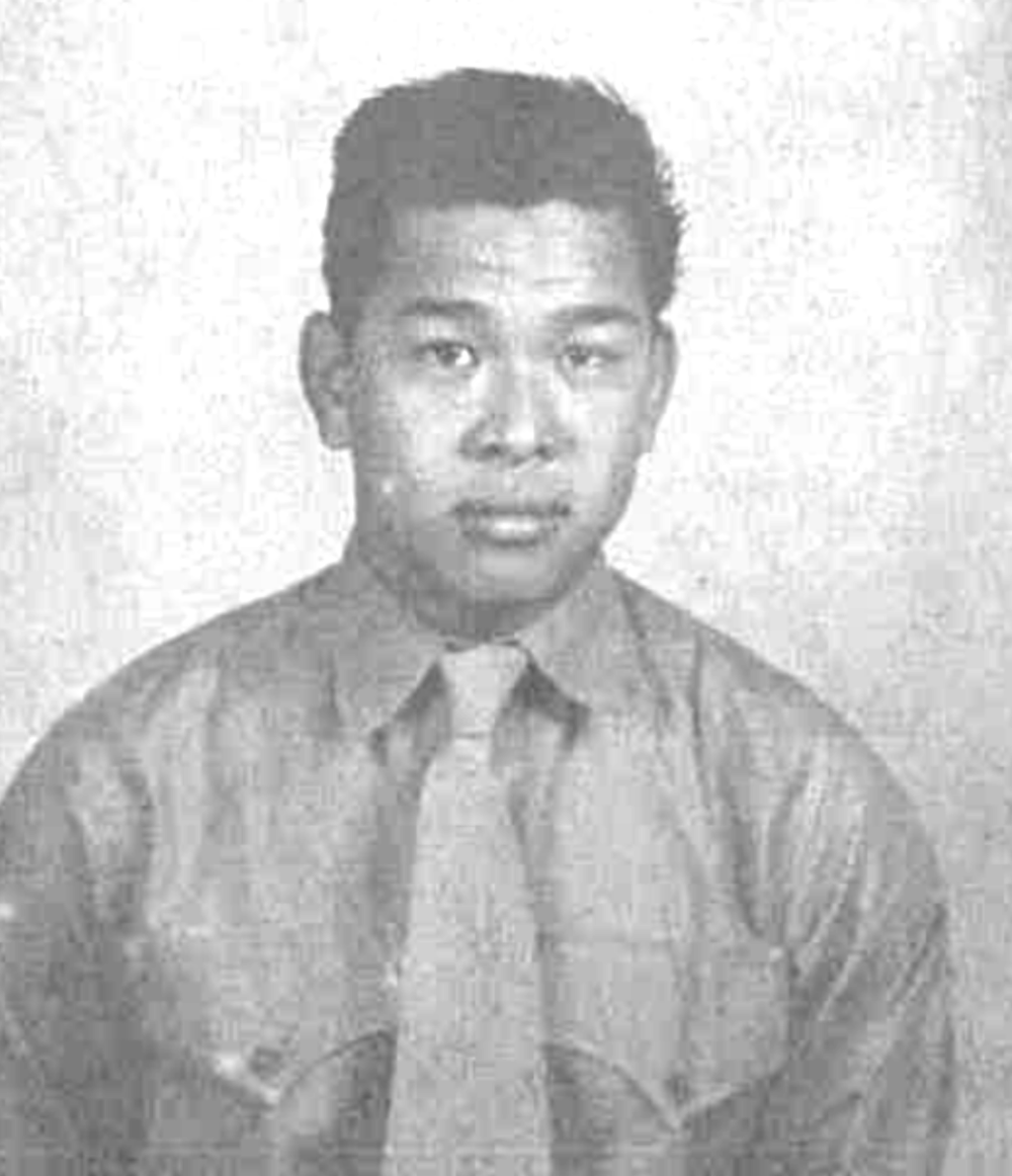 A Chinese American Marine in his dress shirt and tie, looking straight at the camera.