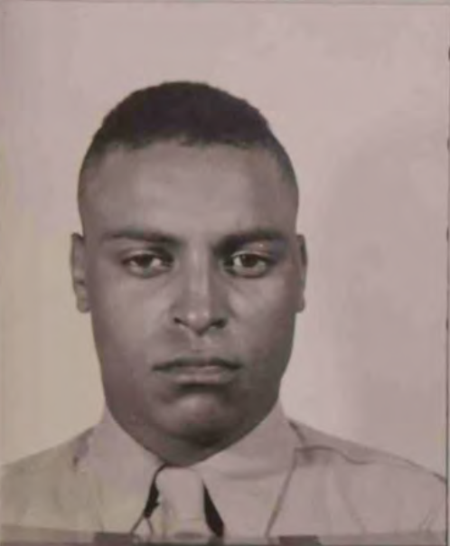 An African American man in a Marine uniform looks at the camera.