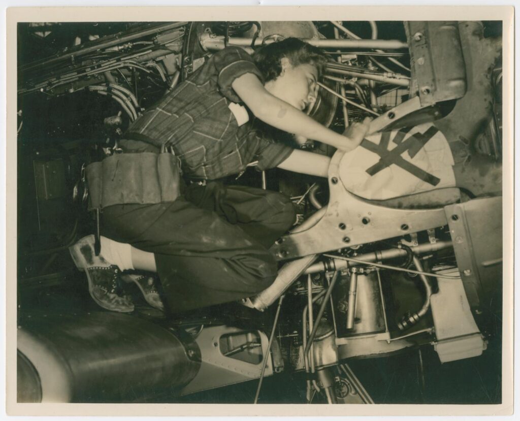 Female flight mechanic working on an airplane at Kelly Field in San Antonio. 