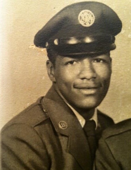 A young African American man smiling in his Air Force uniform.