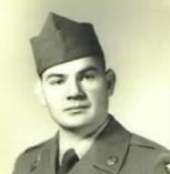 A young man in a Army dress uniform looking at the camera.