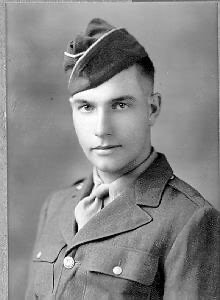 Soldier in uniform looking directly into camera.