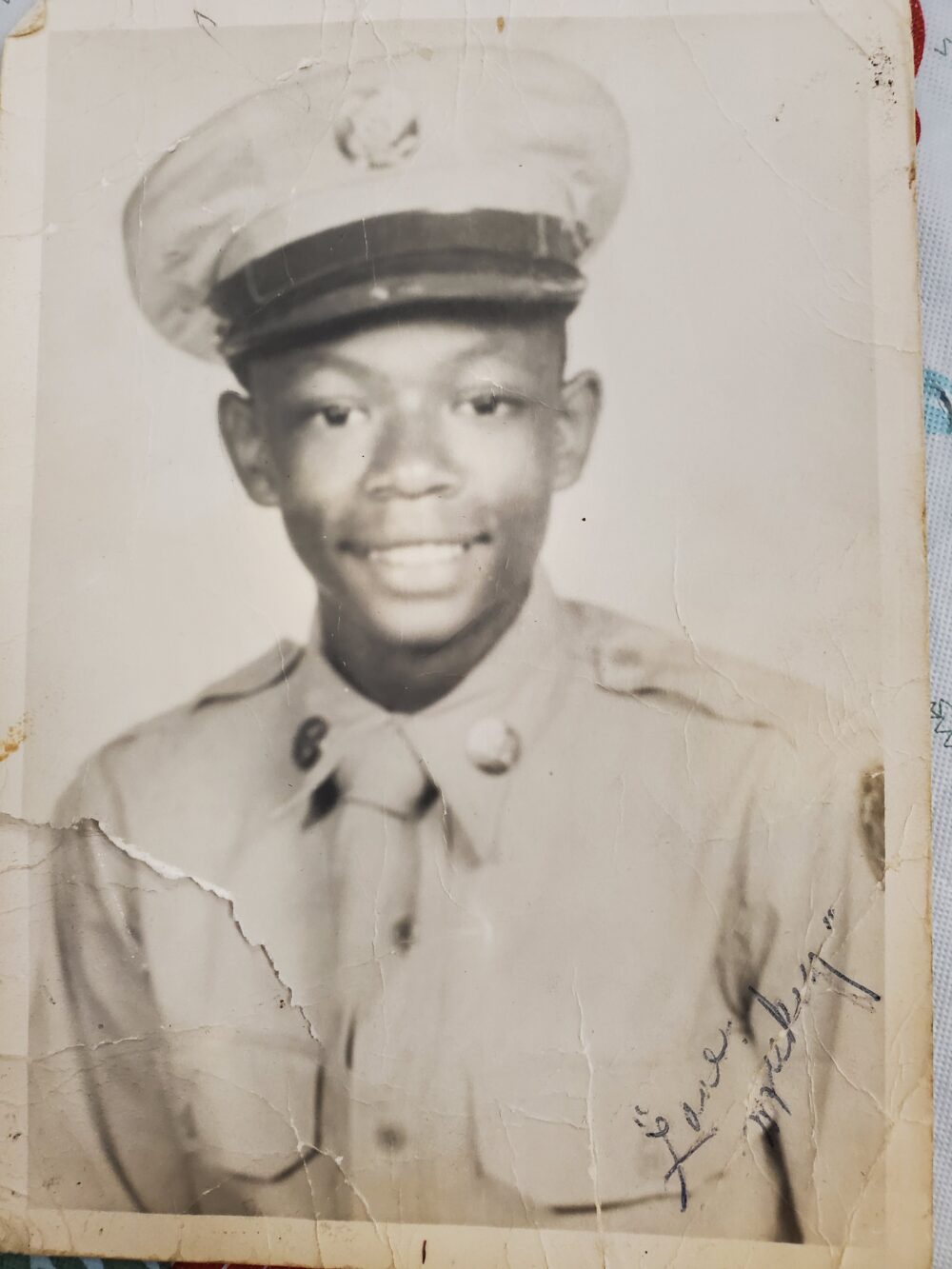 A photograph of Alexander in his military uniform. Love, Mickey is written in the lower right hand corner.