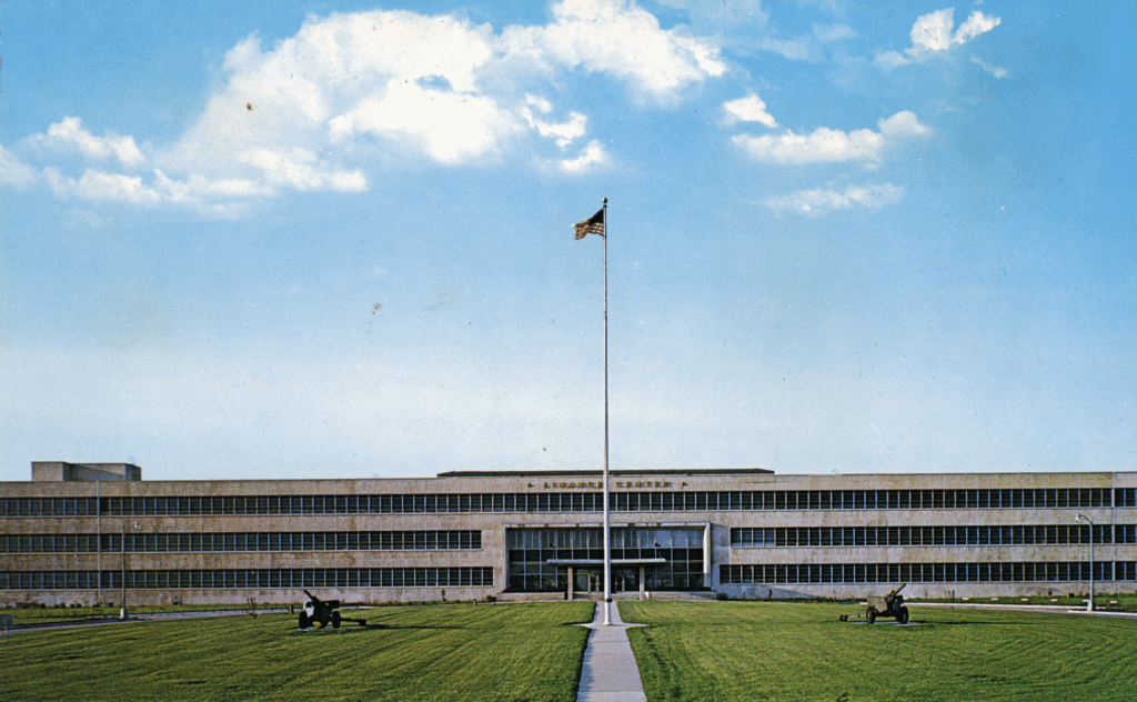 Photo of a large building labeled "Finance Center" with an American Flag in the foreground.