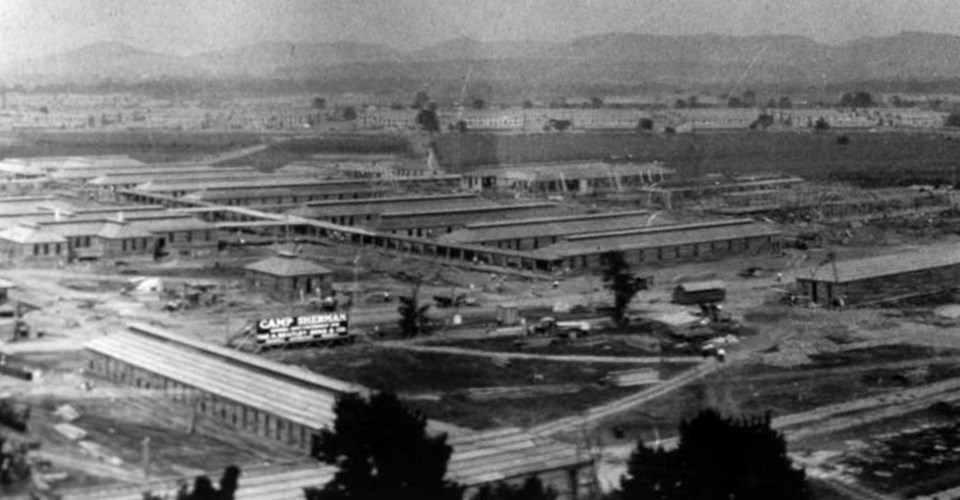 There are several buildings being constructed. Towards the front, on the left side, is a sign reading ‘Camp Sherman.’