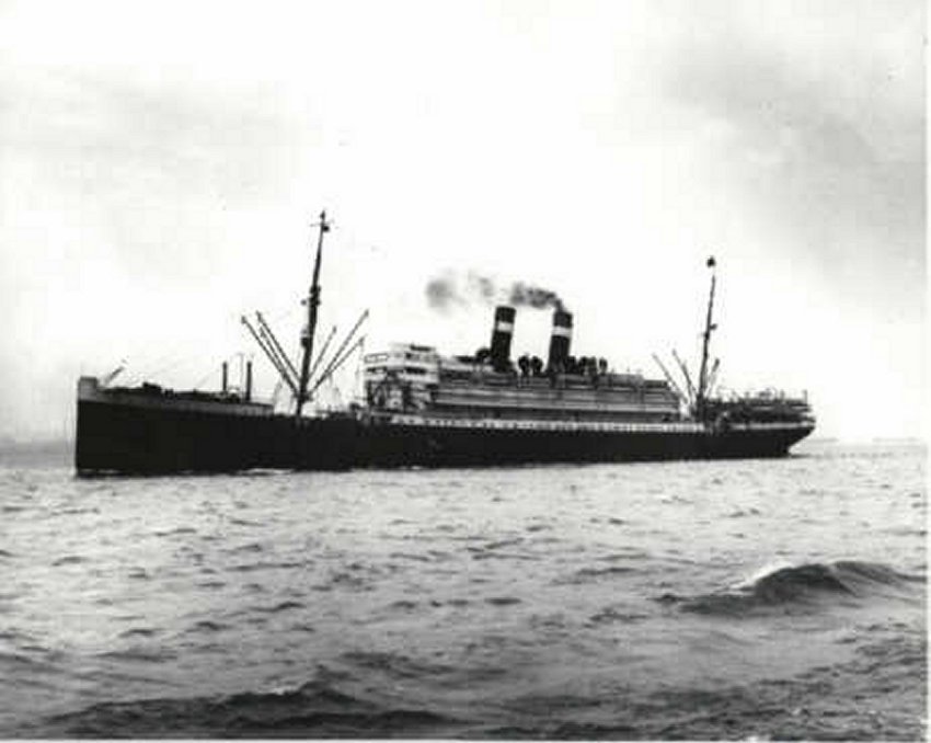Black and white image of the side of the ship in the middle of the sea.