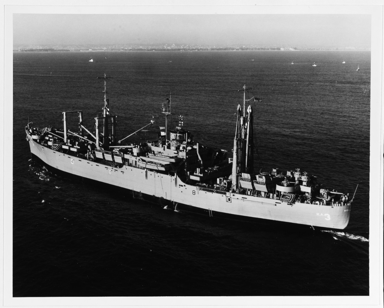 A black and white photo of a battleship in the middle of the Ocean.