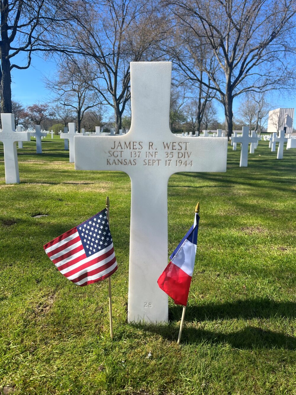 James West's grave at Lorraine American Cemetery with an American and French flag.