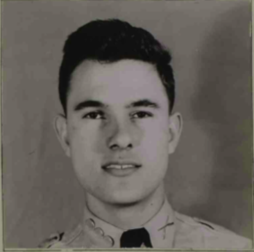 A black and white headshot image of a White male in uniform. He is looking straight at the camera.