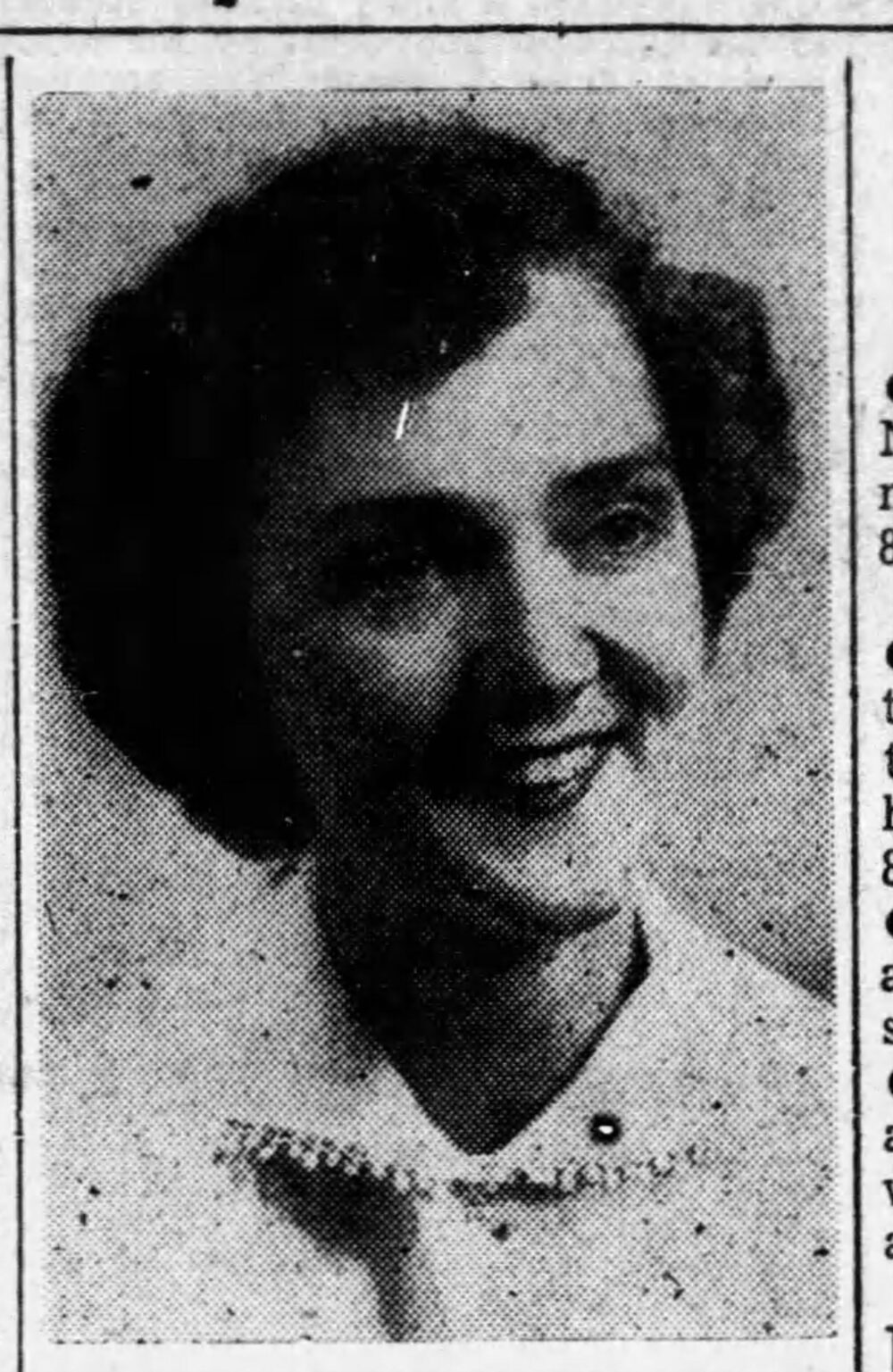 A young woman with dark hair wearing a white blouse.