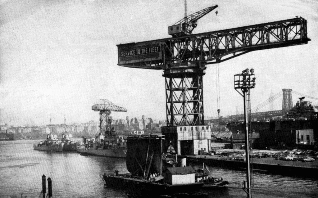 Black and white photograph of several ships in the Navy Ship Yard.