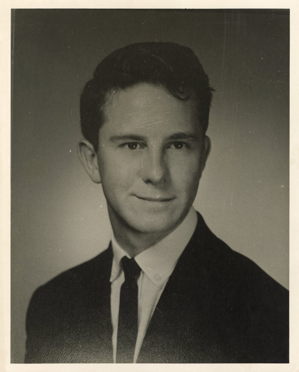 Joe Delong in high school, wearing a jacket and tie.