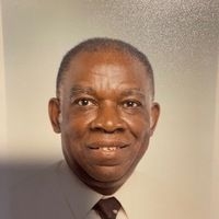 An African American man wearing a shirt and tie.