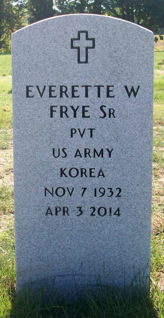 An arched gray marble tombstone engraved with a cross at the top and the words, “Everette W Frye Sr PVT US ARMY KOREA NOV 7 1932 APR 3 2014.”
