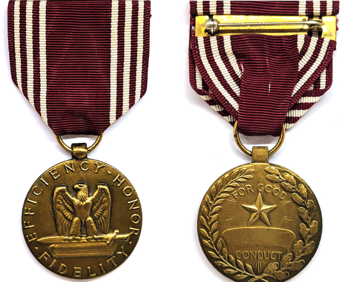 An image of the front and back of a gold medal on a maroon ribbon with white stripes. On the front of the medal is an eagle sitting atop a sword, which is on top of a book. Around the outside it says “efficiency, honor, fidelity.” On the back of the medal is a star in the center of a laurel wreath border. In the middle it says “For good conduct.”