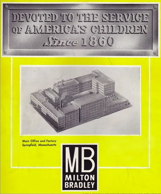 The top of the cover has a plaque meant to look like marble that says, “Devoted to the service of America’s children since 1860.” Underneath is an aerial image of the main office and factory in Springfield, Massachusetts. The compound takes up what appears to be an entire city block. Around that image is a yellow backing and underneath is the Milton Bradley name and ‘MB’.
