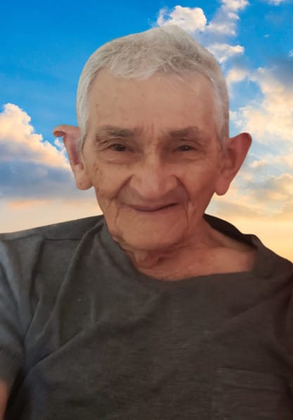 An older man with a background of blue skies.