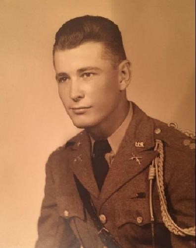 A sepia headshot of a young man in a uniform looking off to the left.