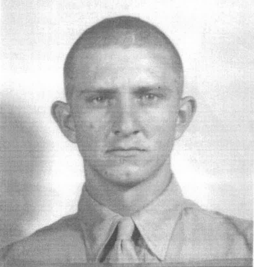 A young man with a shaved head and Marine uniform.