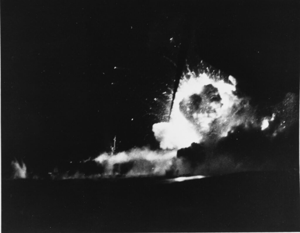 A black and white image showing the Bismarck Sea exploding. Not much can be seen other than an explosion.