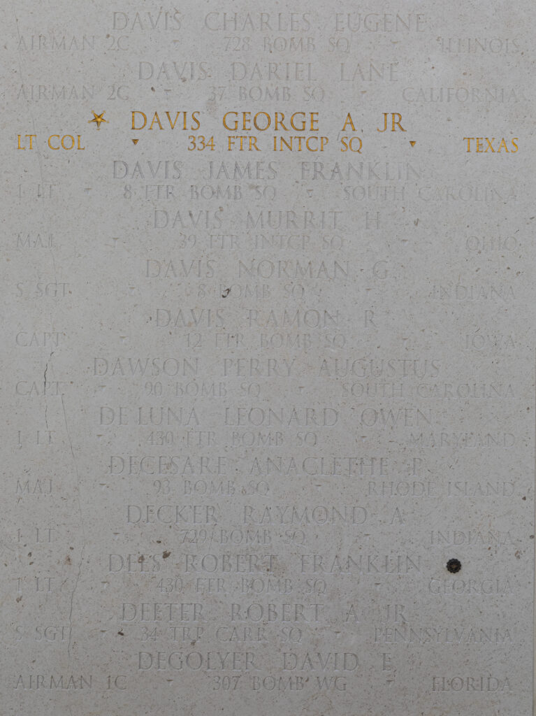 A photo of a white marble walls with several names engraved, including Davis.