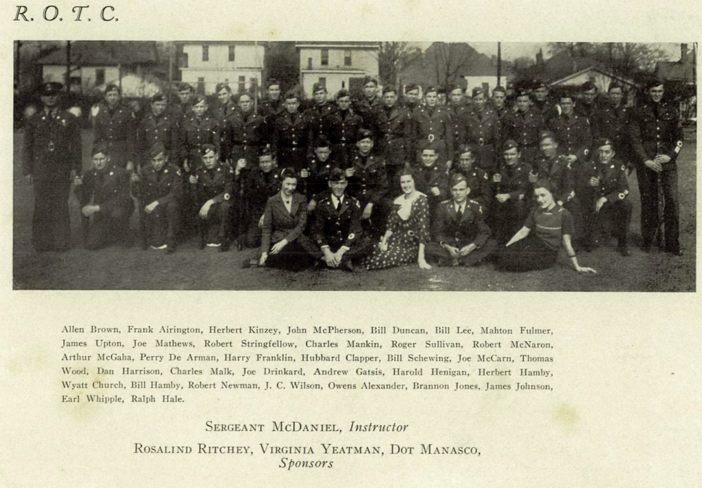 A page from a yearbook shows a large group of dozens of students dressed in uniform gathered on a field. Underneath, their names are listed. 