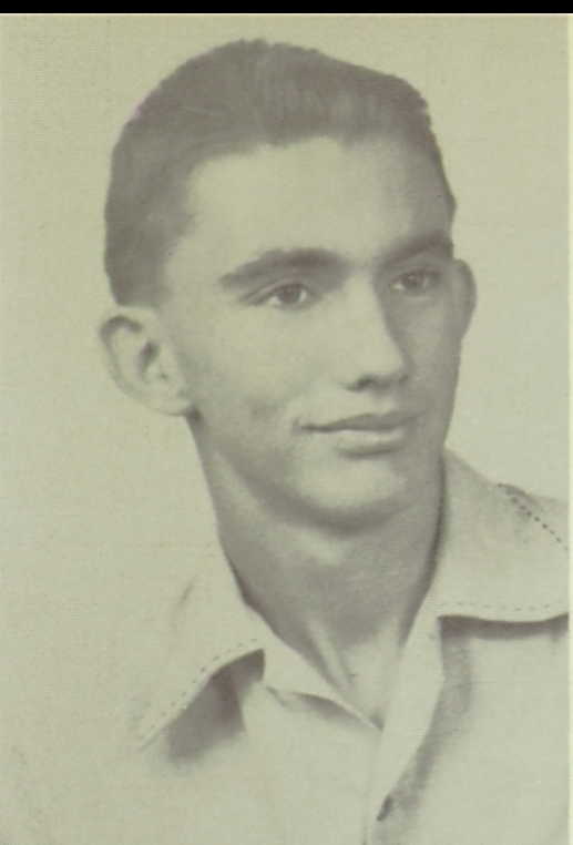 A black and white headshot photo of a White young man in a colored shirt looking off the to side of the camera. 