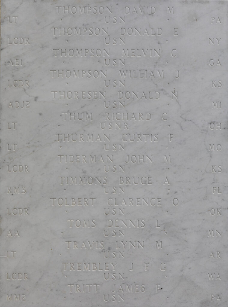 A white marble wall featuring Timmons's name