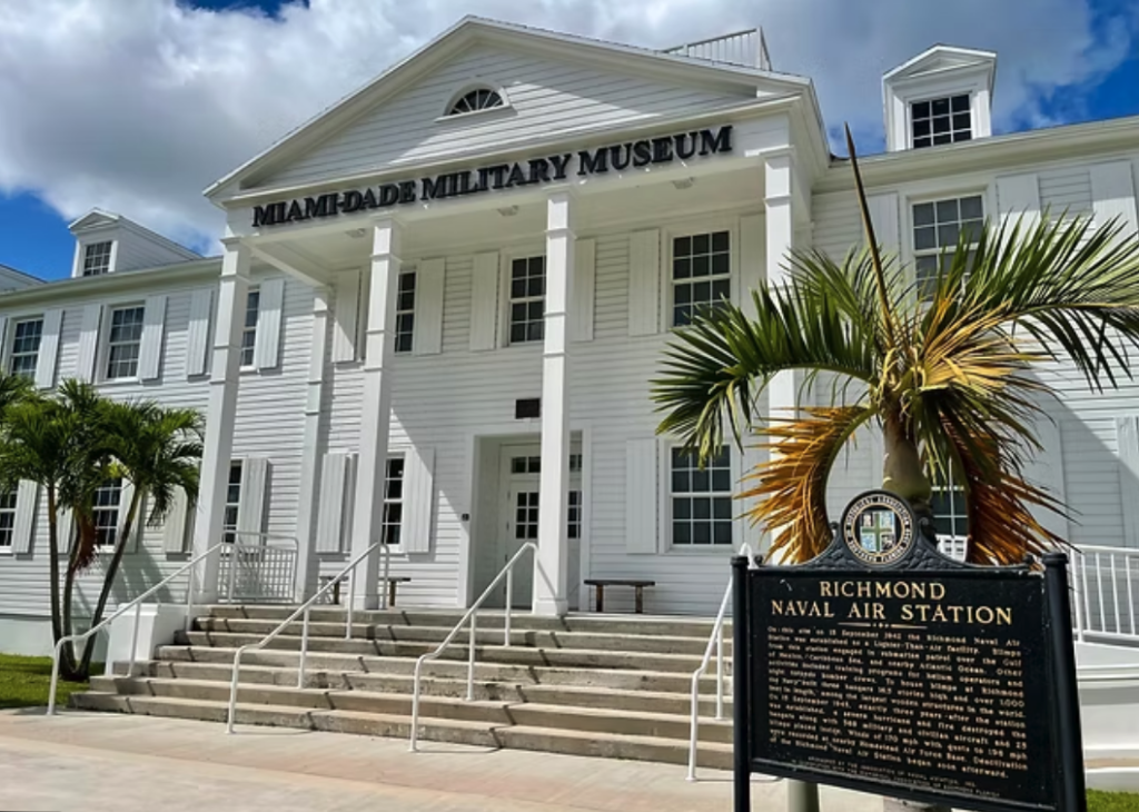 A color photograph of a Greek-style building with two stories. 