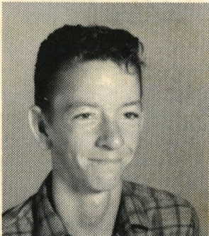 A black and white headshot of a young White boy in a button-up shirt. 