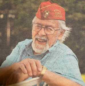 Peter Fabregas as a Veteran, wearing a red service hat denoting his service in the Marine Corps.