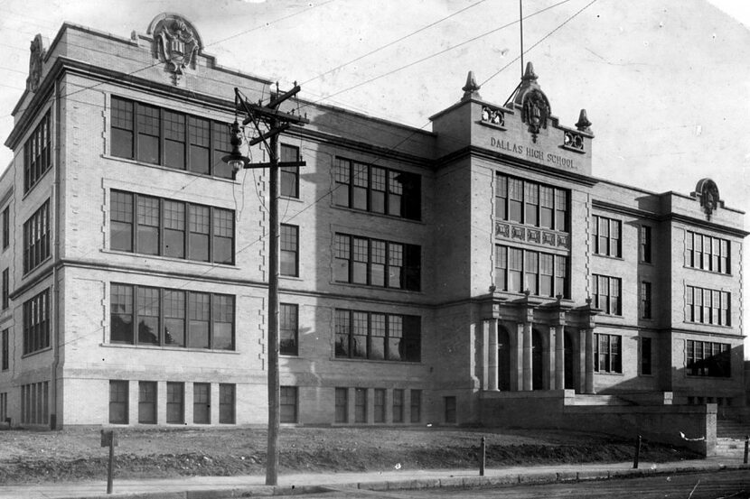 A black and white image of a four-story brick school building, labeled “Dallas High School.”