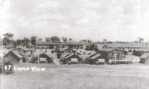 A black and white image of several small camps built in the middle of the field. On the image is written “27 camp view.”