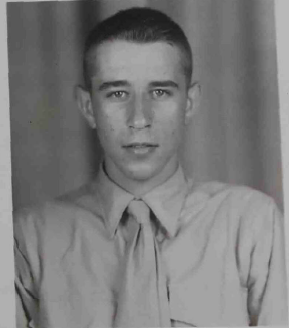 A young man in a Marine Corps uniform looking at the camera.