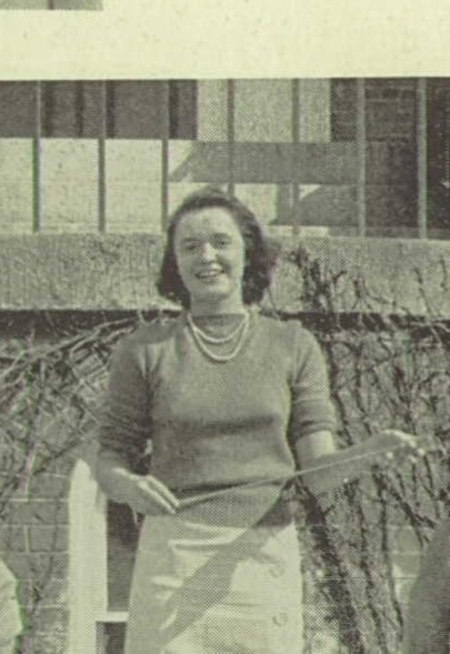 A young woman wearing a skirt and sweater.