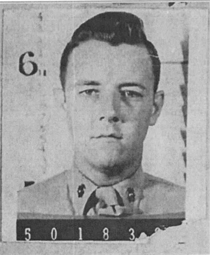 A black and white headshot photo of a young White man in uniform.
