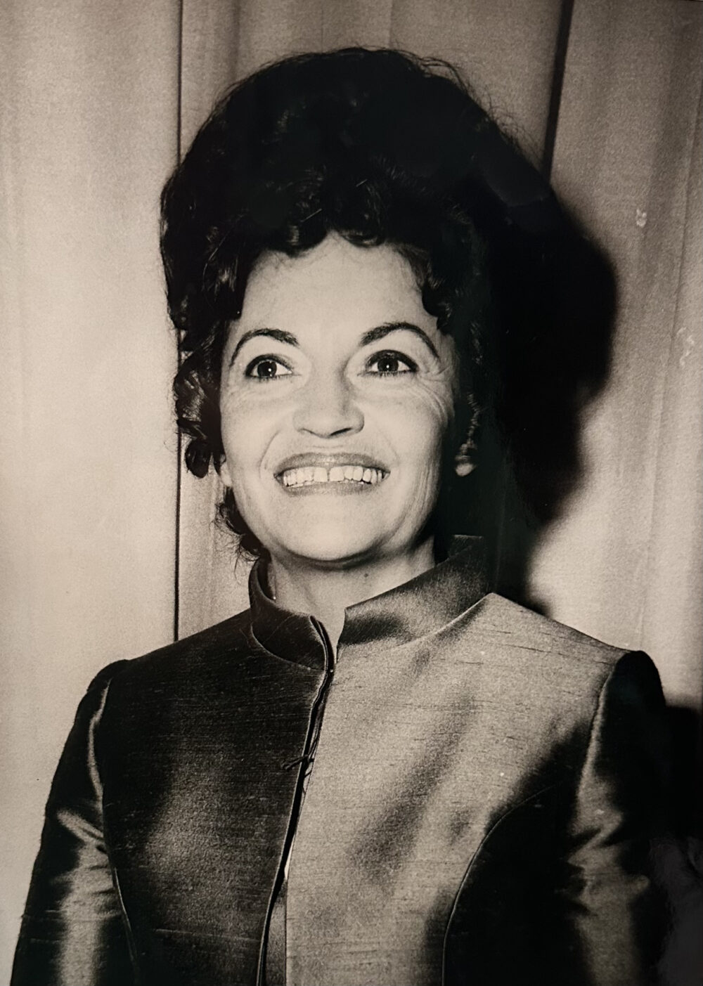 A woman with a large, teased, dark hair up-do.