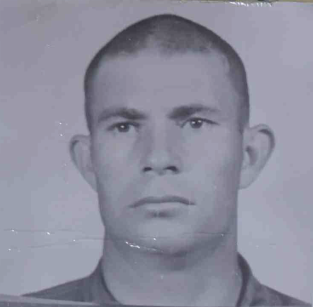 A black and white headshot of a young White man in uniform.