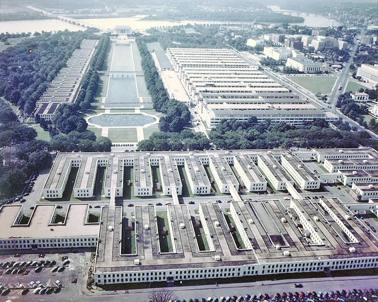 A color, aerial image of several dozen rectangular buildings flanking all sides of the National Mall.