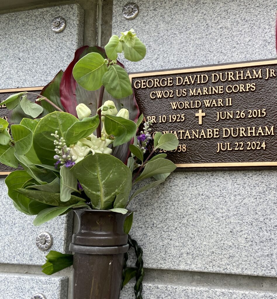 A color photo of a bronze plaque engraved with, “George David Durham Jr. CWO2 US Marine Corps World War II APR 10 1925 June 26 2015, Yoko Watanabe Durham Aprl 26 1938 Jul 22 2024.”