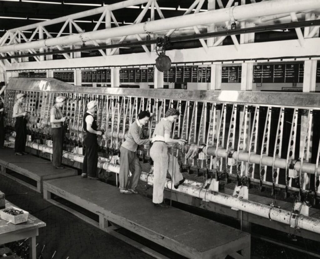 A black and white picture of six White women working in a factory.