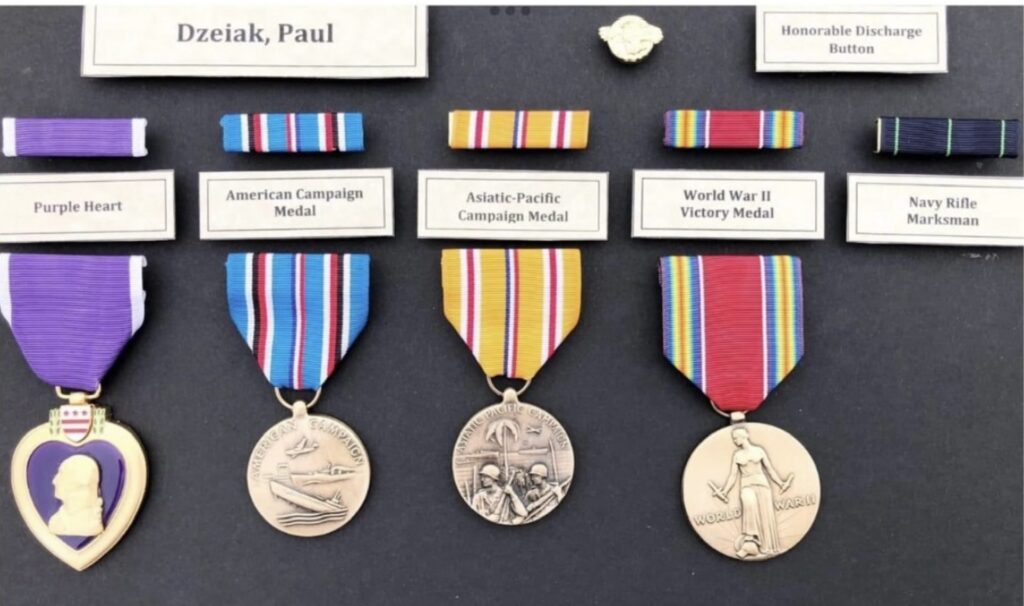 A color photo of multiple medals in a shadowbox. 
