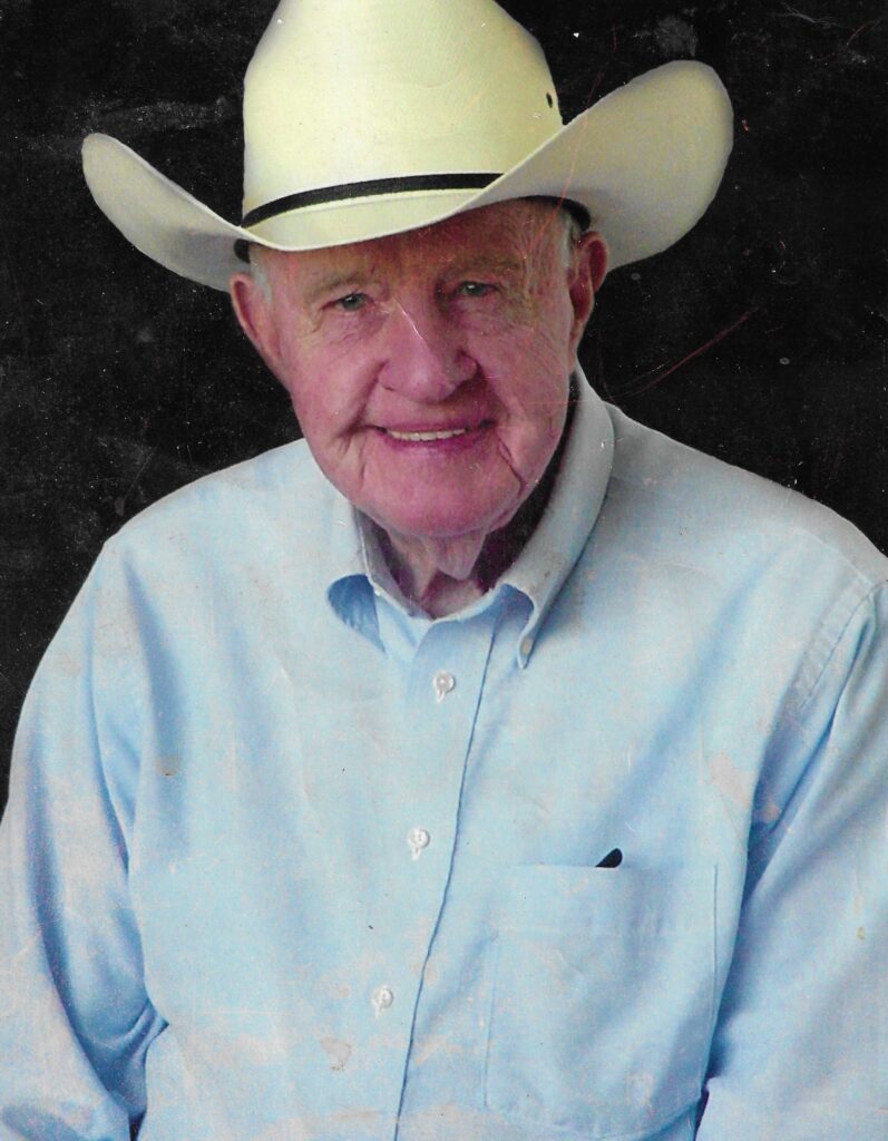 A color headshot of an elderly White man in a cowboy hat.