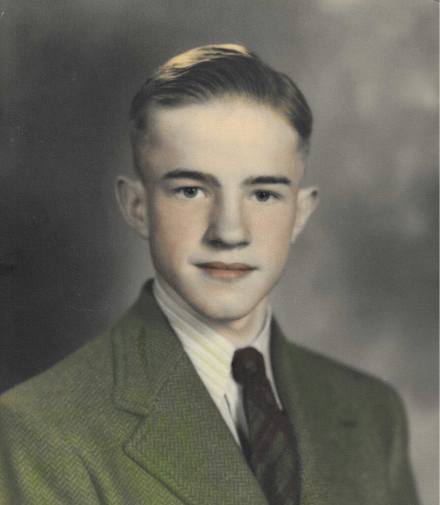 A colorized headshot image of a young White man in a suit and tie.