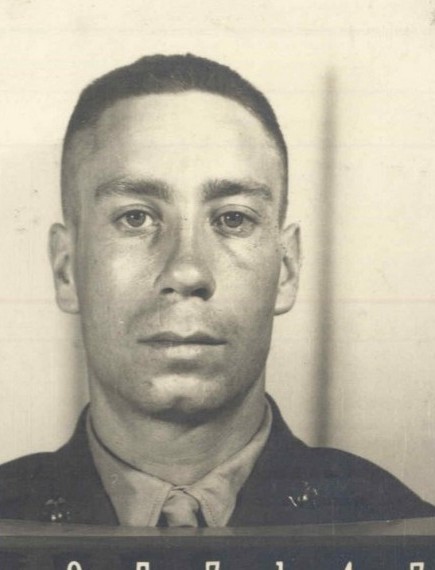 A black and white headshot photo of a young White man in uniform.