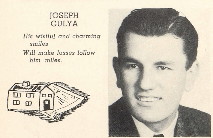 A black and white headshot of a young White boy in a suit and tie. To the left of the image it says, “Joseph Gulya. His wistful and charming smiles will make lasses follow him miles.”