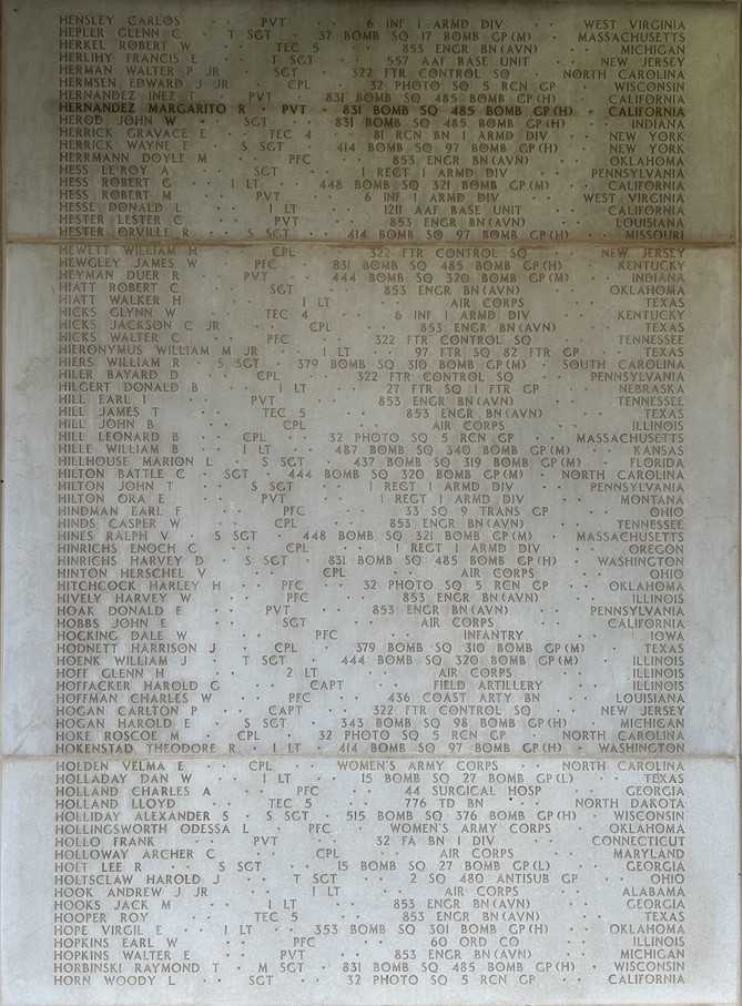 A white marble wall with many engraved names, including Hernandez.