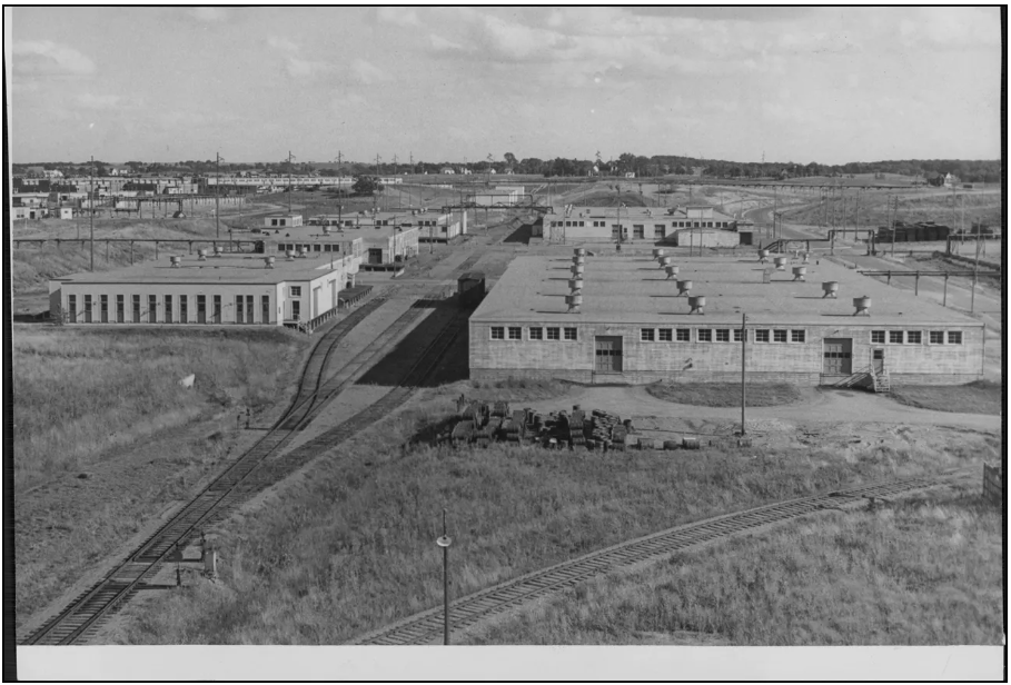A black and white aerial image of several factory buildings.