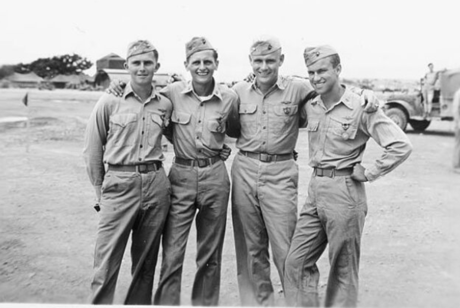 A black and white image of four young White men in uniform.